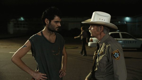 Duke Nicholson and WIlliam H. Macy stand by a crime scene in the film, The Deputy